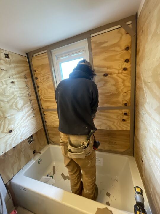 Bathroom wall prep during acrylic shower installation