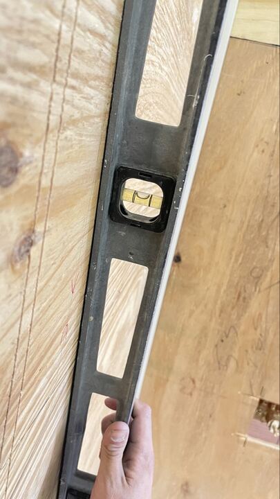Level check during wall preparation with bubble visible